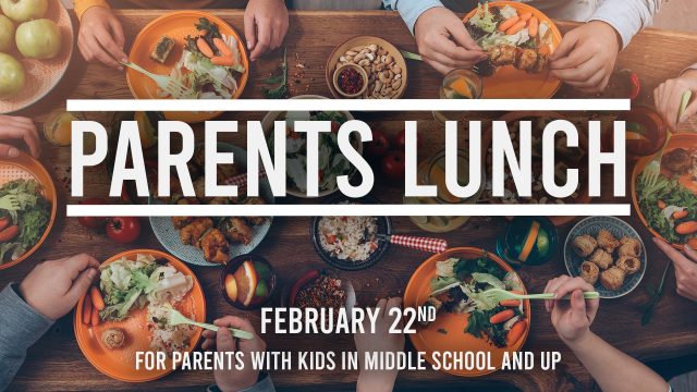 Top view of group of people having dinner together while sitting at the rustic wooden table